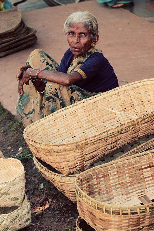 Old lady selling her hand oven baskets