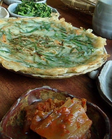 Korean pancake with kimchi on the side