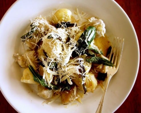 Taro and Potato Gnocchi plated together under browned butter and crispy sage leaves.
