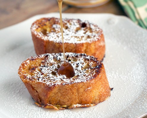 pouring syrup over french toast