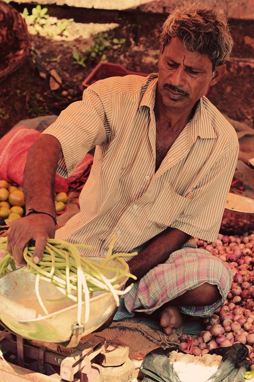 A vendor selling his own produce