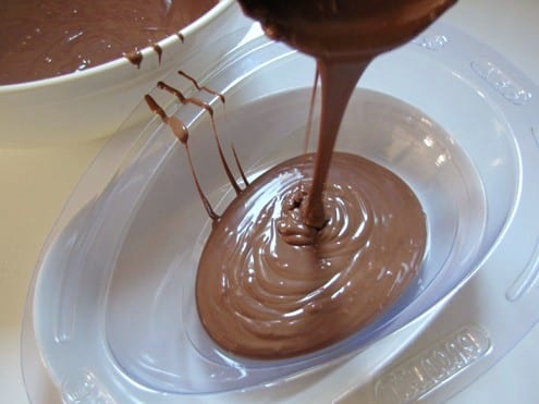 Filling the egg mold with milk chocolate