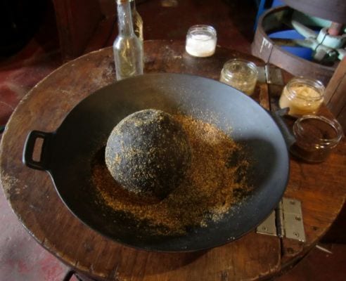 Grinding mustard seeds the old-fashioned way, and the ingredients for mustard: water, vinegar, salt and ground mustard. The herbs that are going in are a secret...