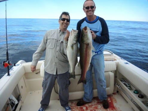 Fisherman with striped bass.