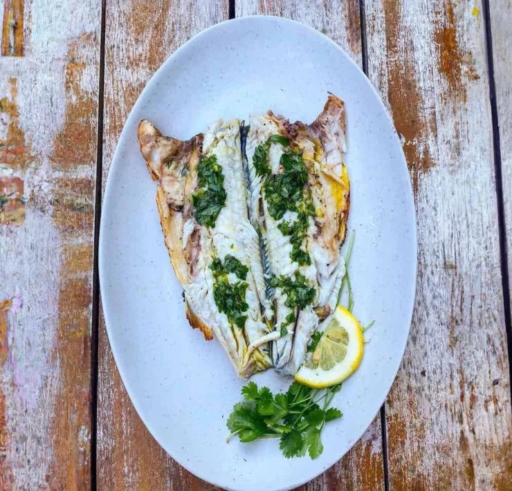 Whole branzino, stuffed with herbs and lemons, quickly touched by the flames of the grill, and served with lemon and herb infused olive oil. 