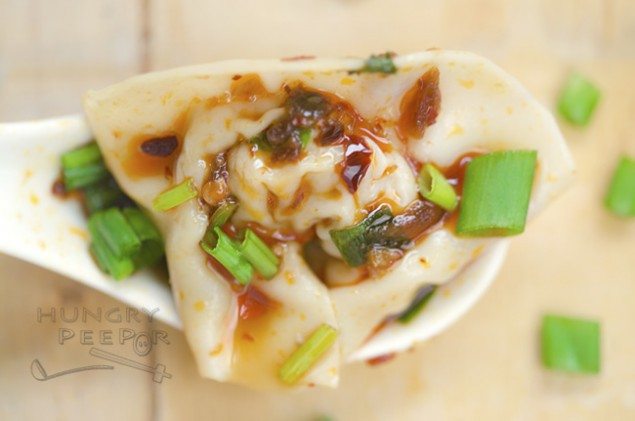 These pork-filled wontons are doused in chili oil and vinegar sauce to be a tangy, spicy, juicy bite we can't get enough of.