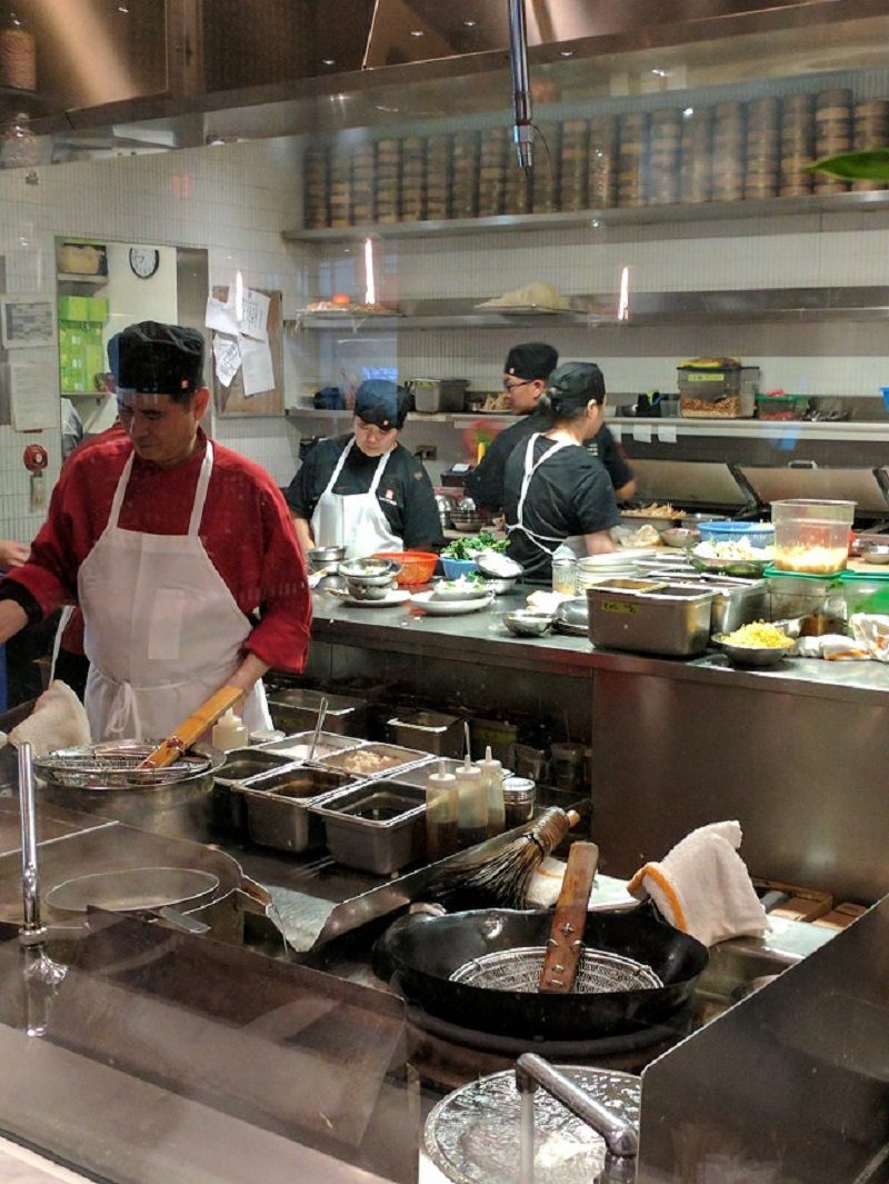 Chefs prepare meals in open kitchen