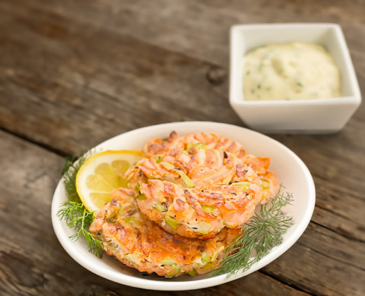 Prepare the Salmon Cakes: Sauté the Aromatics: Heat 2 tablespoons of olive oil in a skillet over medium heat. Add minced onion, red bell pepper, celery, and a pinch of salt. Sauté until the onion is soft and translucent, about 5 minutes. Add capers and cook for an additional minute. Remove from heat and let cool to room temperature. Mix the Salmon Cake Ingredients: In a large bowl, combine the coarsely chopped salmon, sautéed vegetable mixture, 1/4 cup mayonnaise, 1/4 cup panko bread crumbs, minced garlic, Dijon mustard, cayenne pepper, Old Bay seasoning, salt, and pepper. Mix until well combined. Cover the bowl with plastic wrap and chill in the refrigerator for 1-2 hours. Form the Salmon Patties: Shape the chilled salmon mixture into round patties. Sprinkle the remaining panko bread crumbs over each patty. Cook the Salmon Cakes: Heat 1 tablespoon of olive oil in a skillet over medium heat. Cook the patties until golden brown and cooked through, about 3 to 4 minutes per side. Prepare the Remoulade Sauce: Mix the Ingredients: In a bowl, combine 1/2 cup mayonnaise, 1/4 cup Dijon mustard, 1 tablespoon capers, 2 tablespoons diced tomato, and 1 teaspoon sriracha. Season with salt and pepper to taste. For a smoother sauce, process the mixture in a food processor. Serve: Serve the salmon cakes hot with the remoulade sauce on the side. Recipe Notes Ensure the salmon cakes are thoroughly chilled before forming into patties to help them hold together better while cooking. Adjust the cayenne pepper and Old Bay seasoning according to your heat preference. The remoulade can be made a day in advance and stored in the refrigerator.