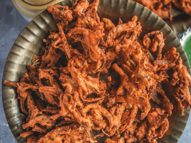 Onion Pakoda is a famous street food from India. These bhajiyas are crispy and crunchy onions mixed in chickpea flour and spices.