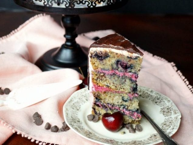 This Dark Chocolate Cherry Cake is a total stunner and happens to be vegan. Vanilla cake is studded with fresh cherries and chocolate chunks, sandwiched with a fresh cherry filling, and crowned with a dreamy chocolate ganache.