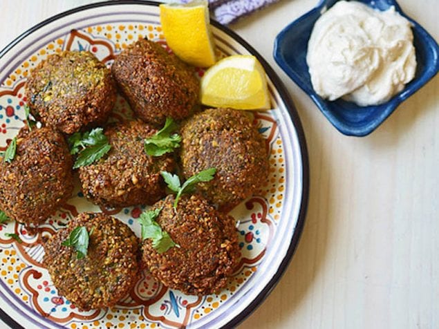 Learn how to make homemade Lebanese falafel recipe with dried chickpeas, loads of fresh herbs and warm spices. Serve the crispy balls with a creamy tahini yogurt.