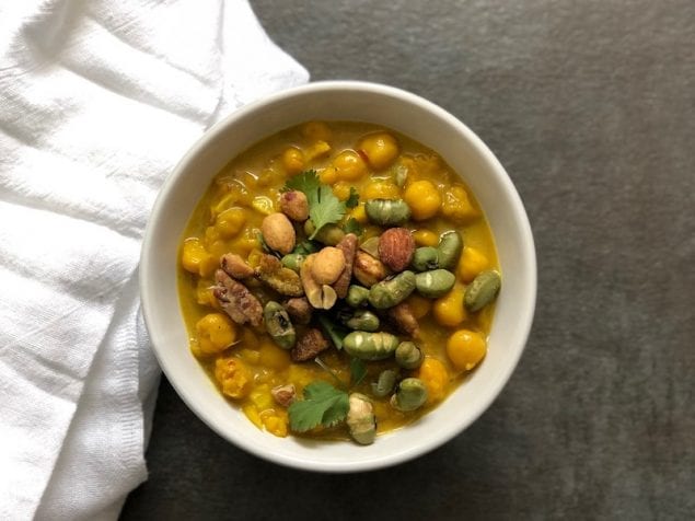 A cozy chickpea soup loaded with lime, turmeric, and a crunchy topping of honey mustard-glazed nuts and seeds.