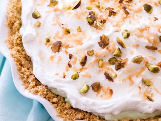 This homemade pistachio pudding cream pie is layers of graham cracker crust, pistachio pudding cream, and whipped cream. Plus, it is filled with sweet pineapple and coconut. Easy and no-bake.