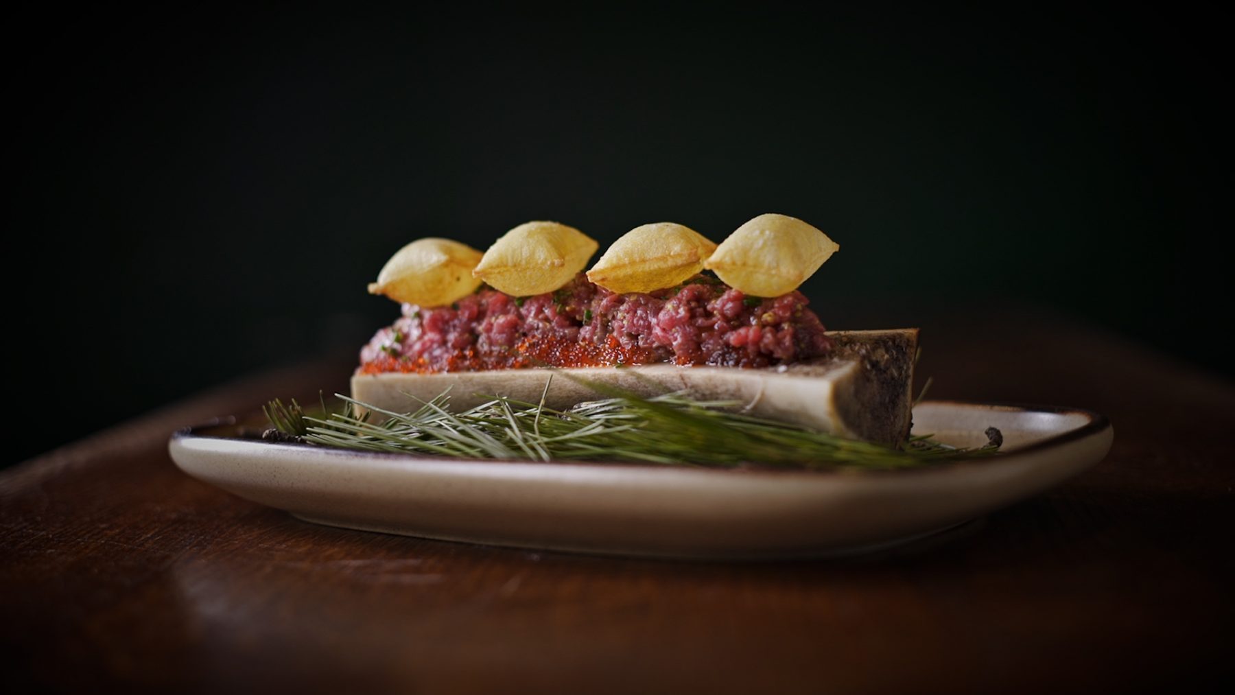 Steak Tartare On Grilled Bone Marrow And Pommes Souffle By Chef Toni Romero