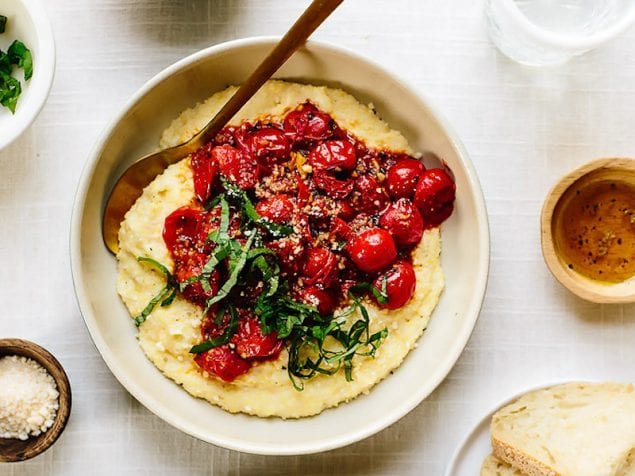 This 30-minute vegan burst cherry tomato polenta is bound to become a weeknight staple. Rich cashew cream is woven through hot polenta. Then, the polenta is served generously topped with burst garlic-herb cherry tomatoes.