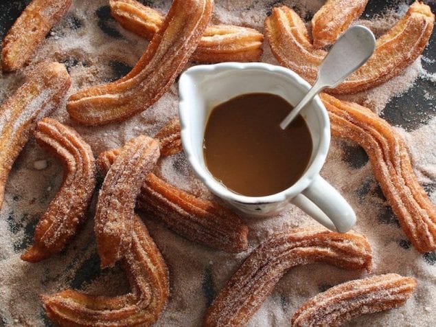 The cinnamon-sugar coated, fried dessert is one of our favorites. Especially when we have a rich chocolate sauce or bitter coffee to drunk it in. Going beyond just the usual sticks, here are our favorite churro desserts.