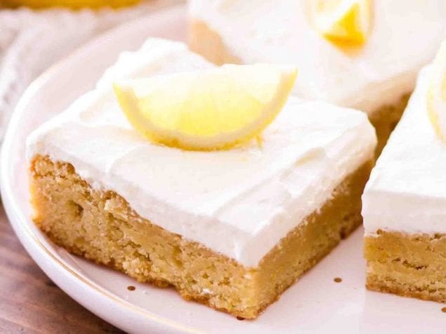 These easy Lemon Bar Blondies are rich, chewy and that perfect combination of sweet and tart. Top with a lemon whipped cream frosting to make them irresistible.