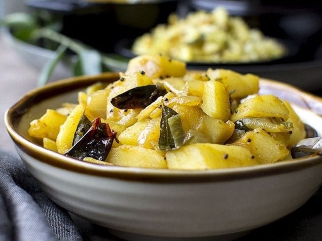 Bombay Aloo aka Masala Potatoes is an easy to make, everyday curry that is great to serve with both rice or Roti. Flavored with spices and laced with sweet caramelized, this potato curry is sure to be a family favorite.