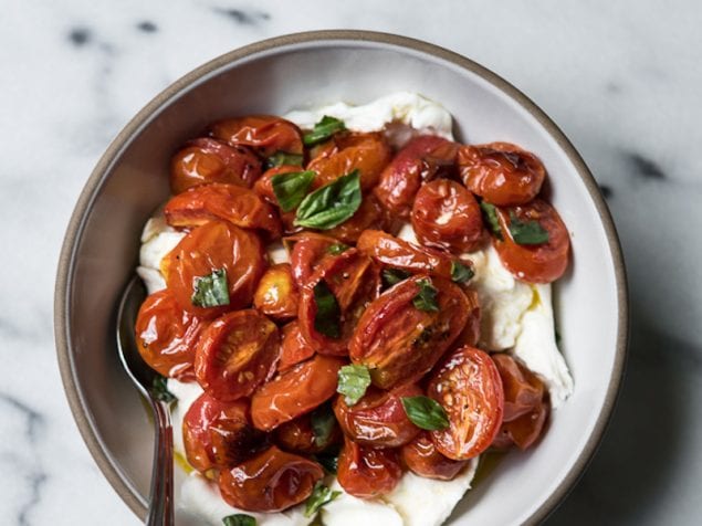 Dreamy, roasted tomatoes are served over a bed of soft burrata cheese as an easy appetizer with crackers or a simple side dish for summer.