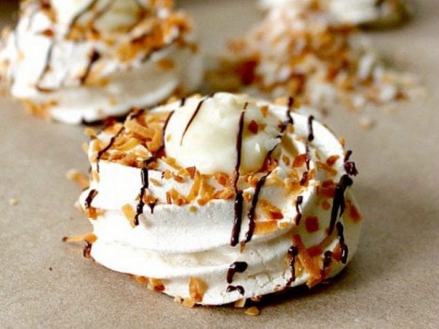 Toasted Coconut Mini Pavlovas with Coconut Custard! Crisp meringue nests house a creamy coconut custard filling in these beautiful treats.