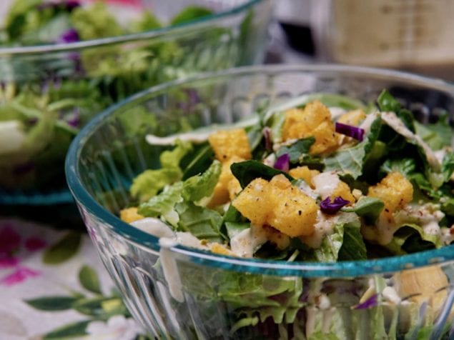 Here's how to make a delicious Caesar salad, with all vegan ingredeints. A rich, creamy, and totally crave-worthy dressing, with crushed pistachios, pecans, and crispy polenta croutons on the greens.